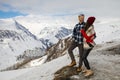 A loving couple plays together in the snow outdoors. Winter holidays in the mountains.