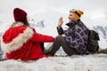 A loving couple plays together in the snow outdoors. Winter holidays in the mountains.