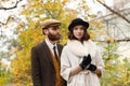 Loving couple posing in park. The guy is looking at the girl. Retro. Outdoors.