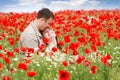 Loving couple on red poppies field Royalty Free Stock Photo