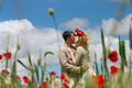 Loving couple on red poppies field Royalty Free Stock Photo
