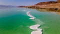 Loving couple is resting on the dead sea. Salt coastline, The sea in Israel dies out and dries up Royalty Free Stock Photo