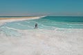 A loving couple is resting on the dead sea. Salt coastline, The sea in Israel dies out and dries up Royalty Free Stock Photo