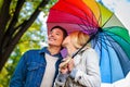 Loving couple on romantic date under autumn umbrella. Royalty Free Stock Photo