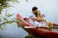 Loving couple rowing on the lake