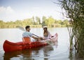 Loving couple rowing on the lake