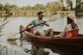 Loving couple rowing on the lake