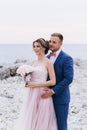 Loving couple on the seashore. Wedding. Newlyweds.