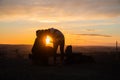 Loving couple in shade during colored sunset in quarry Hady Brno with view inside city