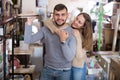 Loving couple in shop of secondhand furniture