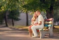 Loving couple sitting on banch in park