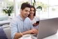 Loving couple sitting in cafe using laptop computer Royalty Free Stock Photo