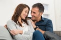 Loving Couple Sitting On Couch