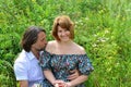 Loving couple sitting on the grass in summer Royalty Free Stock Photo