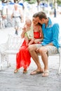 Loving couple sitting on a vintage white bench outdoor Royalty Free Stock Photo