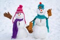 A loving couple of snowmen. Christmas background with couple of snowman. Snowman couple outdoor. Cute snow man in hat