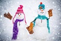 A loving couple of snowmen. Christmas background with couple of snowman. Snowman couple outdoor. Cute snow man in hat Royalty Free Stock Photo