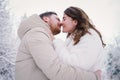 Loving couple on a snowy winter field. Happy together.