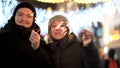 Loving couple with sparklers smiling, looking into eyes in winter city at night, Merry Christmass and New Year concept Royalty Free Stock Photo