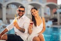 Loving couple spending vacation on tropical resort swimming pool.Newlyweds honeymoon on seaside.Couple in true love Royalty Free Stock Photo