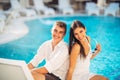 Loving couple spending vacation on tropical resort swimming pool.Newlyweds honeymoon on seaside. Royalty Free Stock Photo