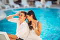 Loving couple spending vacation on tropical resort swimming pool.Newlyweds honeymoon on seaside. Royalty Free Stock Photo