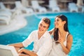 Loving couple spending vacation on tropical resort swimming pool.Newlyweds honeymoon on seaside. Royalty Free Stock Photo