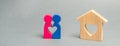 A loving couple is standing near a wooden house. The concept of finding a house or apartment for a young family. Affordable Royalty Free Stock Photo