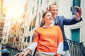 Loving couple take a photo with modern smart phone on the one of