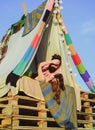 Loving couple in tent. Pair in love hugging and kissing in camping. Portrait of happy man woman hug outdoor.