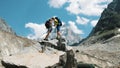 Loving couple of tourists with backpacks in the hike kiss on the top in the mountains. The concept of love, achievement Royalty Free Stock Photo