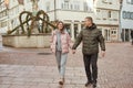 Loving couple of tourists walking around old town. Couple of lovers leisurely stroll in the cool autumn Royalty Free Stock Photo