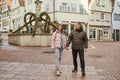 Loving couple of tourists walking around old town. Couple of lovers leisurely stroll in the cool autumn Royalty Free Stock Photo