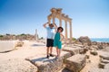 A loving couple of travelers pose with a view of the ruins of the ancient Roman temple of Apollo. Side, Tourism and tours in Royalty Free Stock Photo