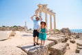 A loving couple of travelers pose with a view of the ruins of the ancient Roman temple of Apollo. Side, Tourism and tours in Royalty Free Stock Photo