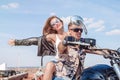 Loving couple travels on a motorcycle near the ocean. Family, tourism, love concept