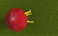 Loving couple or two friends in yellow rubber boots are sitting on the green lawn covered with grass under a red umbrella in rainy