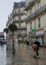 Loving couple under an umbrella on a rainy day in Nantes, France