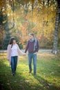 Loving couple walk holding hands in the autumn park Royalty Free Stock Photo