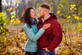 Loving couple walking in the autumn forest and hugging