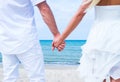 Loving couple walking and embracing on the beach Royalty Free Stock Photo