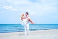 Loving couple walking and embracing on a summer beach Royalty Free Stock Photo