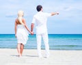 Loving couple walking and embracing on a summer beach Royalty Free Stock Photo