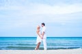 Loving couple walking and embracing on a summer beach Royalty Free Stock Photo