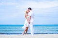 Loving couple walking and embracing on a summer beach Royalty Free Stock Photo