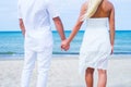 Loving couple walking and embracing on a summer beach Royalty Free Stock Photo