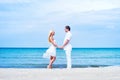 Loving couple walking and embracing on a summer beach Royalty Free Stock Photo