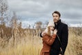 Loving couple walks in the autumn Park, hugs and kisses. Woman i Royalty Free Stock Photo