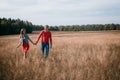 The loving couple walks on the wheat field Royalty Free Stock Photo