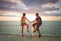 Loving couple watching sunset at the sea Royalty Free Stock Photo